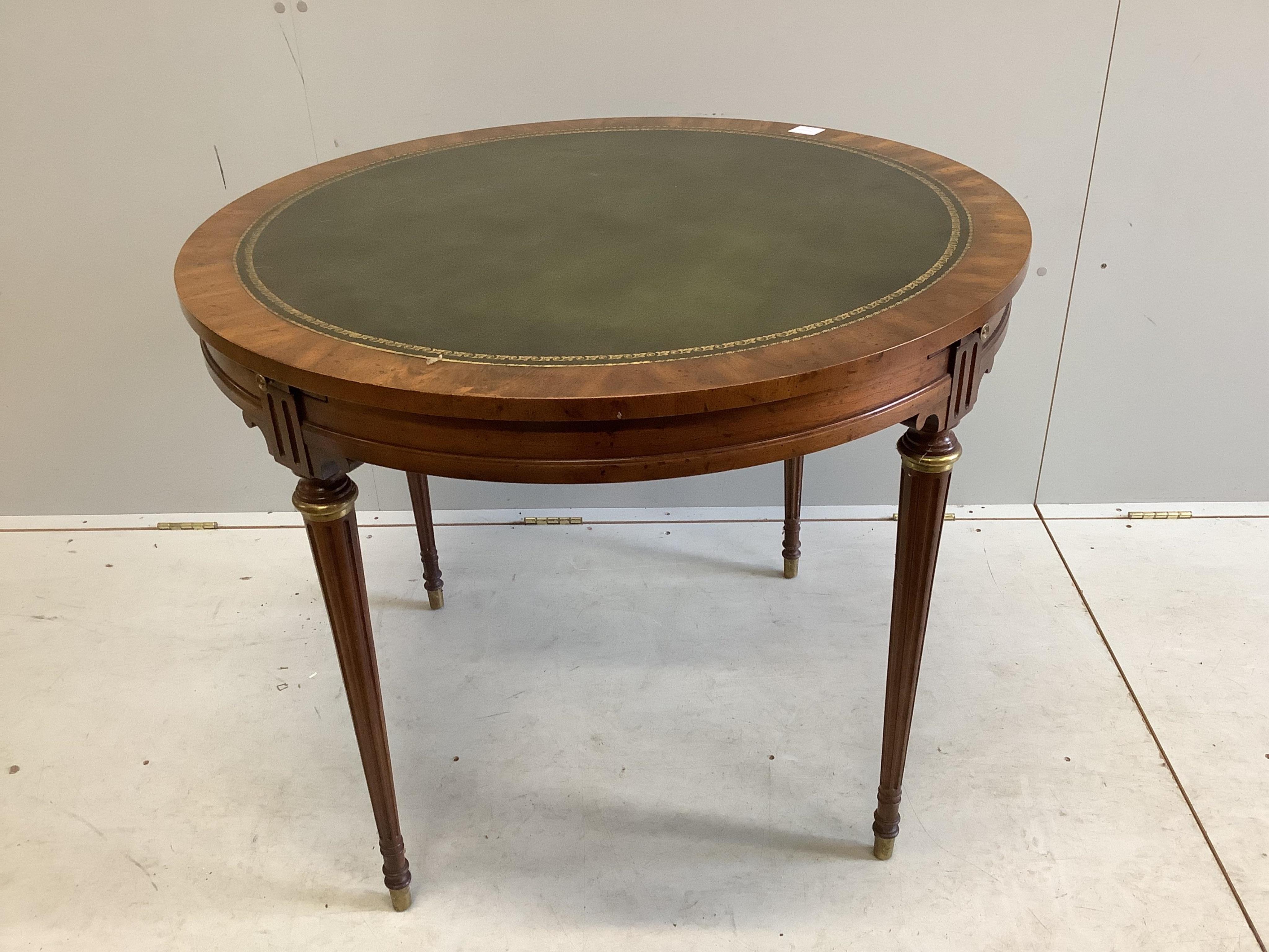 An Empire style circular mahogany games table, diameter 92cm, height 74cm and four caned chairs. Condition - fair to good